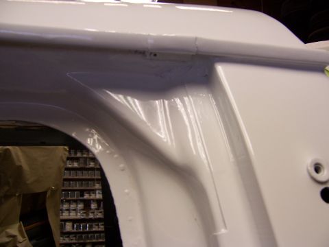 1993 Ford C-350 (Centurion Conversions) - Close-up view of a white vehicle body panel, showing construction details.