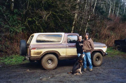 1979 Ford Bronco - Two people and a dog pose with a muddy 1978 Ford Bronco in a wooded area.