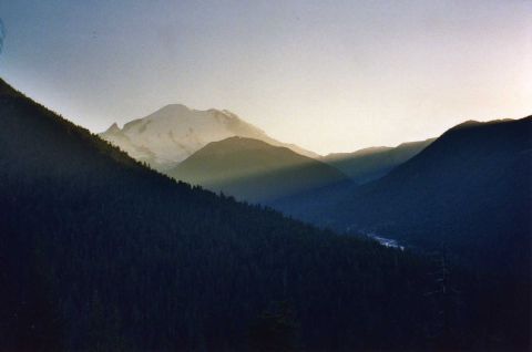 2001 Ford Taurus - Sunrise over a mountain valley with sunbeams illuminating the sky and slopes.