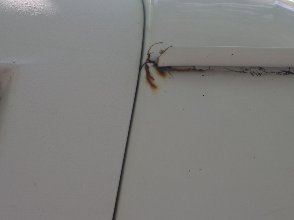 rust spot same on both sides up by drip rail above door