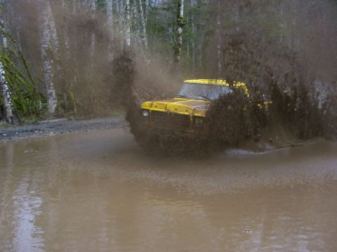 1990 Ford Bronco - 1990 Ford Bronco splashes through a muddy water crossing.