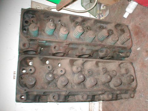 1979 Ford Bronco - Two engine cylinder heads are shown, likely from a V8 engine, with their valve springs intact.