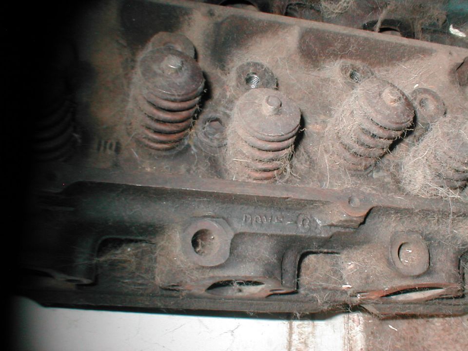 Dusty cast-iron cylinder head with valve springs and D0VE Ford casting number