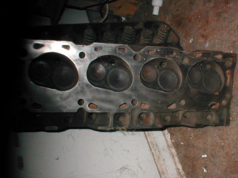 1979 Ford Bronco - Close-up view of an engine cylinder head, showing its internal components and structure.