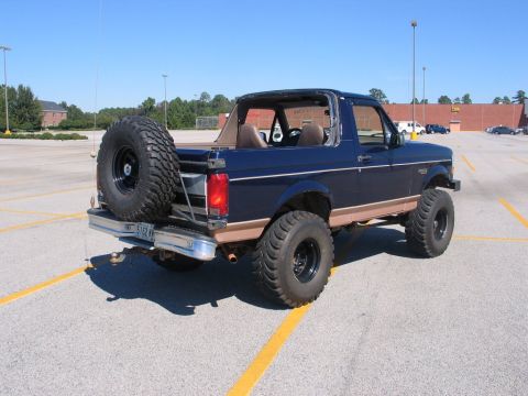 1995 Ford Bronco - This lifted 1995 Ford Bronco is parked in a lot with its top removed.
