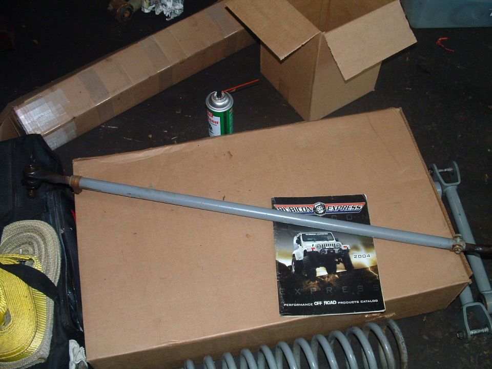 Tie rod assembly and a 2004 Rubicon Express catalog on cardboard boxes
