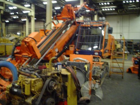 1966 International School Bus - This industrial drilling machine is parked indoors, showing its complex engine and operator cab.