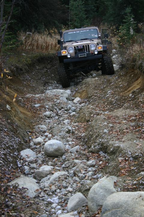 2003 Jeep TJ - Jeep TJ navigates a challenging rocky terrain on an off-road trail.