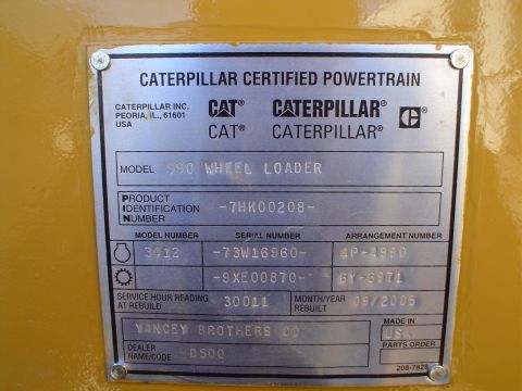 1966 International School Bus - A Caterpillar data plate shows model and serial information for a 990 Wheel Loader.