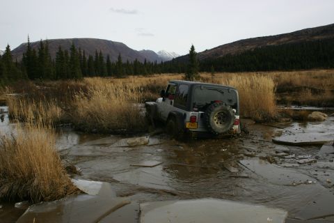 2003 Jeep TJ - Jeep TJ Wrangler navigating difficult terrain with mud and ice.