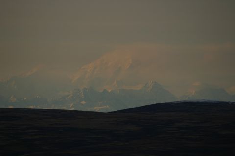 2003 Jeep TJ - A vast mountain range is visible through a hazy sky, with dark hills in the foreground.