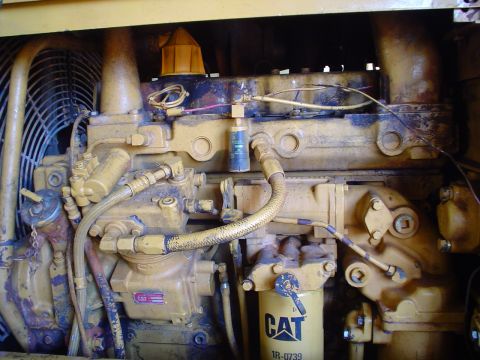1966 International School Bus - Caterpillar engine parts including a yellow fuel filter and cooling fan.