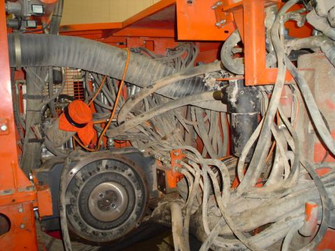 1966 International School Bus - The engine compartment is filled with a dense network of hoses and wiring, suggesting a complex piece of machinery.
