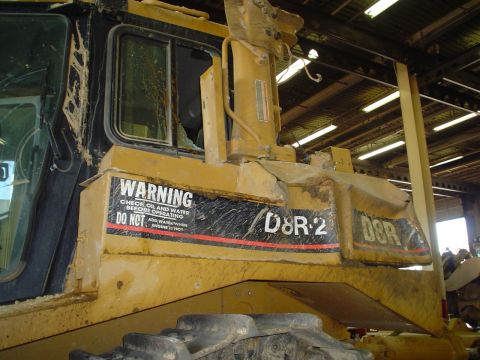 1966 International School Bus - Construction equipment cab shows warning labels and model designation D8R-2.