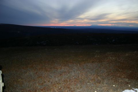 2003 Jeep TJ - A vast mountain landscape is visible under a dramatic sky as dusk settles in.