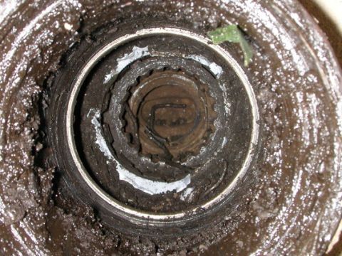 1989 Ford Bronco - Worn wheel bearing hub assembly showing internal splines and grease buildup.