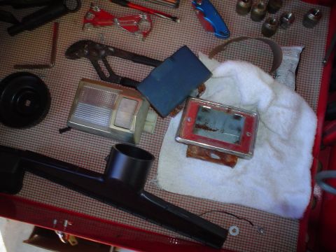 1984 Ford Bronco - Various automotive interior parts and tools are organized on a surface, suggesting a rebuild or repair project.