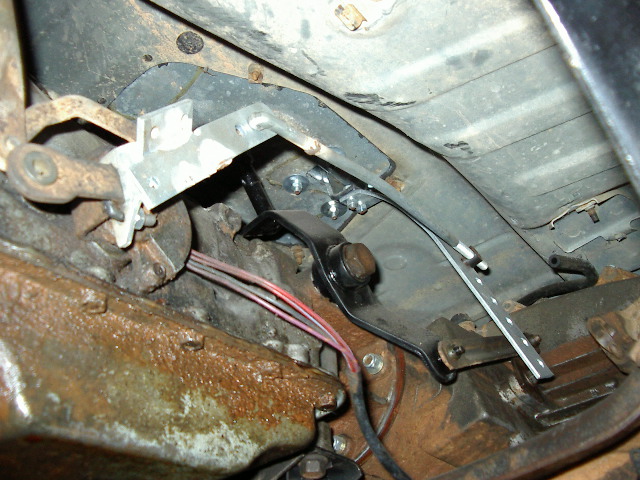 Underneath view of vehicle's shifter linkage and transmission tunnel