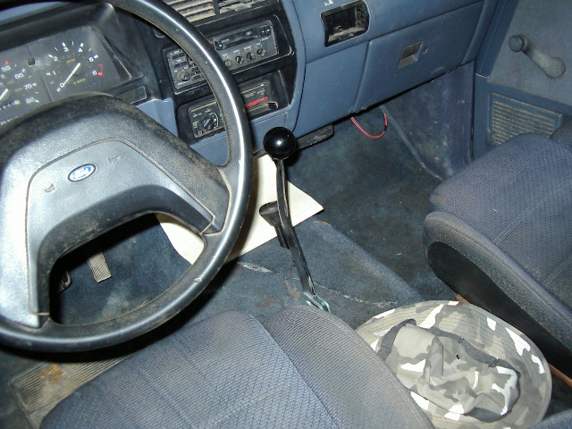 1985 Ford Bronco interior showing dashboard, steering wheel, and shifter