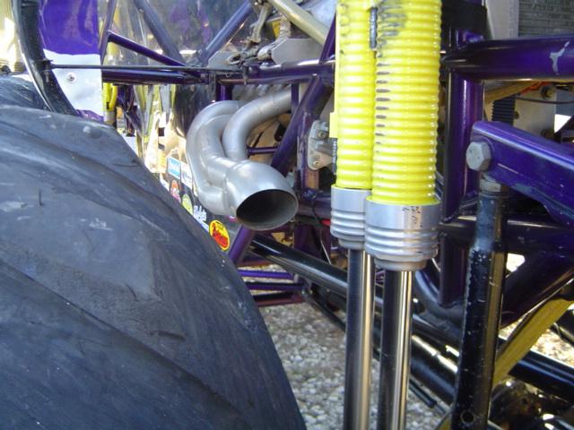 Exhaust pipe and yellow suspension hoses on a custom vehicle