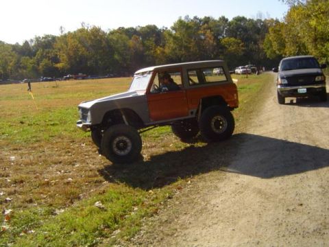 1979 Ford Bronco - Customized 1978 Ford Bronco navigating a dirt path during an outdoor event.