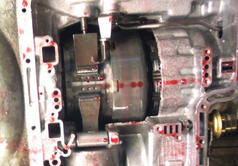 1978 Ford Bronco - Close-up view of internal transmission components, showing metal parts and fluid residue.