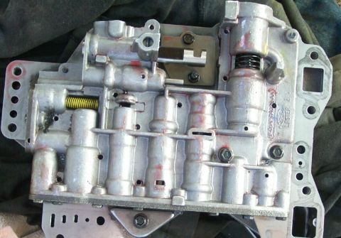 1978 Ford Bronco - Close-up of an automatic transmission valve body, showing internal components and a visible Ford part number.