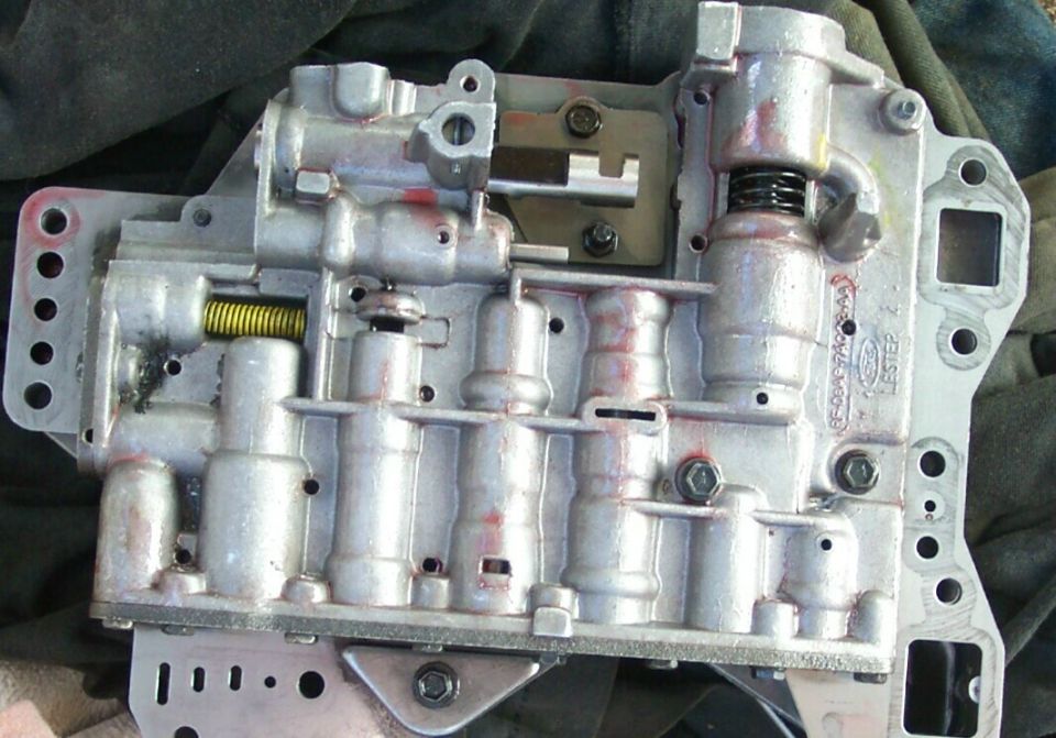 Automatic transmission valve body with visible springs and solenoids. Ford part number visible