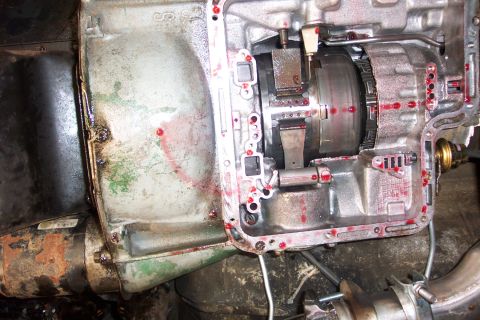 1978 Ford Bronco - This is a close-up view of an automatic transmission, showing internal components and red fluid markings.