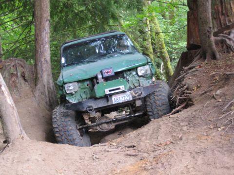 1990 Ford Bronco - This off-road vehicle navigates a challenging dirt path, its capabilities.
