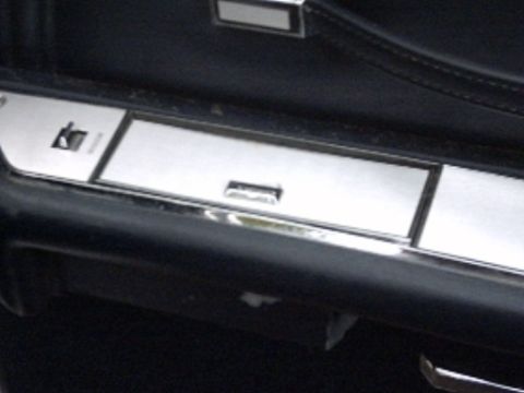1991 Ford Crown Victoria LTD - Interior door panel detail with chrome accents and a lock mechanism.