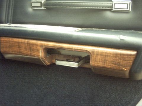 1991 Ford Crown Victoria LTD - Interior shot showing wood-grain trim and a chrome pull handle.