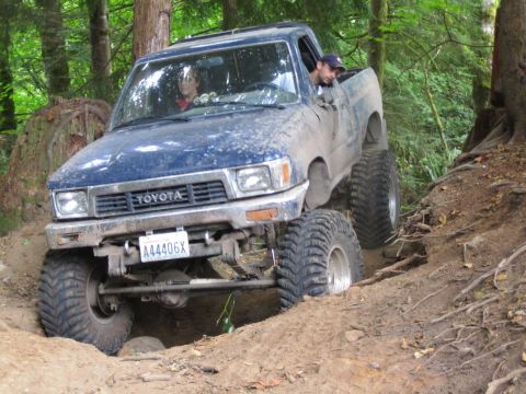 1990 Ford Bronco - This modified Toyota pickup truck is equipped for extreme off-roading on a muddy trail.