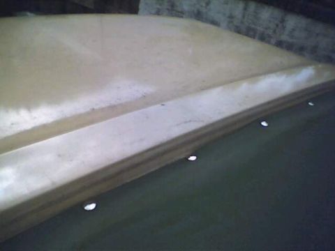 1994 Ford Bronco - Close-up of a vehicle's tan soft top roof, showing mounting points.