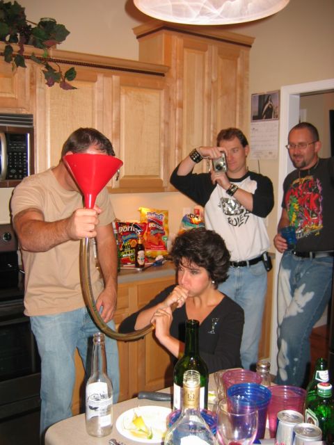 1985 Ford LTD Crown Victoria - A group of friends enjoys a party, with one person using a beer funnel while another takes a photo.