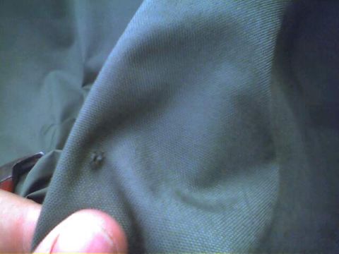 1994 Ford Bronco - Green fabric with a small hole is visible in the image.