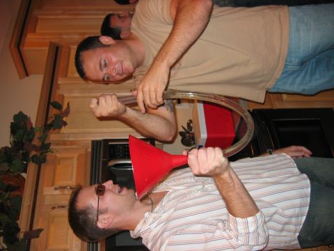 1985 Ford LTD Crown Victoria - Men engage in a party game involving a funnel and tube for drinking.