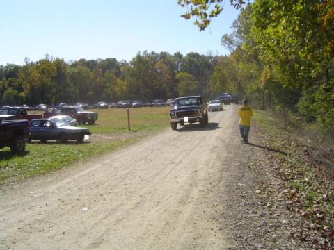 1979 Ford Bronco - A 1979 Ford Bronco is parked on a dirt road during an outdoor event.