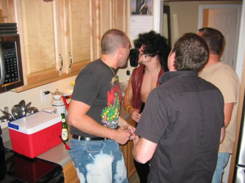 1985 Ford LTD Crown Victoria - Men socializing in a kitchen during a party.