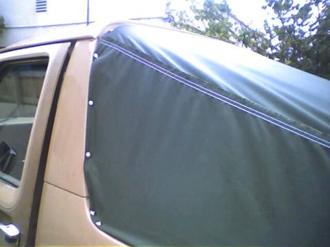 1994 Ford Bronco - The soft top is attached to the vehicle's body with multiple snaps.