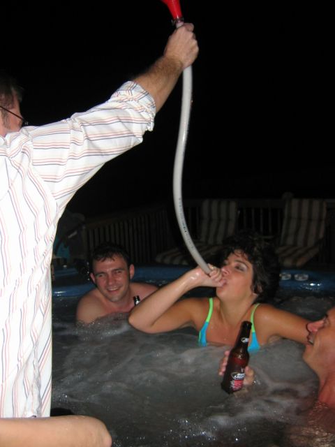 1985 Ford LTD Crown Victoria - A group of friends enjoys a night in a hot tub, with one person using a hose for a drink.