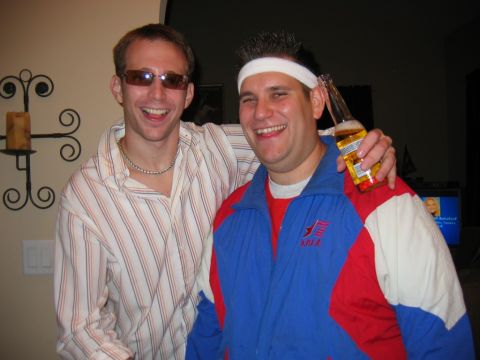 1985 Ford LTD Crown Victoria - Two friends pose for a photo at a party, one holding a beer and wearing a colorful jacket.