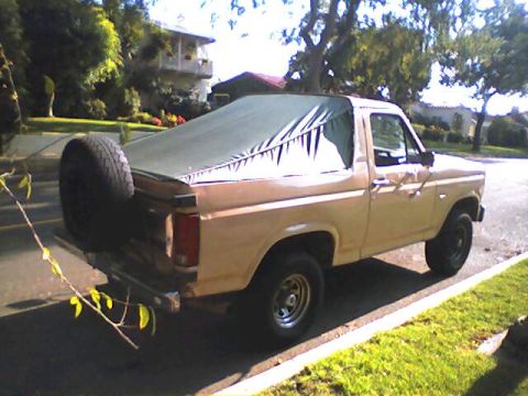 1994 Ford Bronco - This is a 1980s Ford Bronco, not a 1994 model, with a soft top covering the rear.