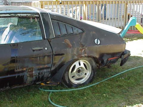 1978 Ford Mustang II - This 1978 Ford Mustang II is seen from the side, its distinctive louvers on the rear window.