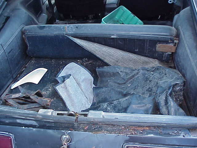 1978 Ford Mustang II trunk interior showing carpet, a green plastic bin, and other items