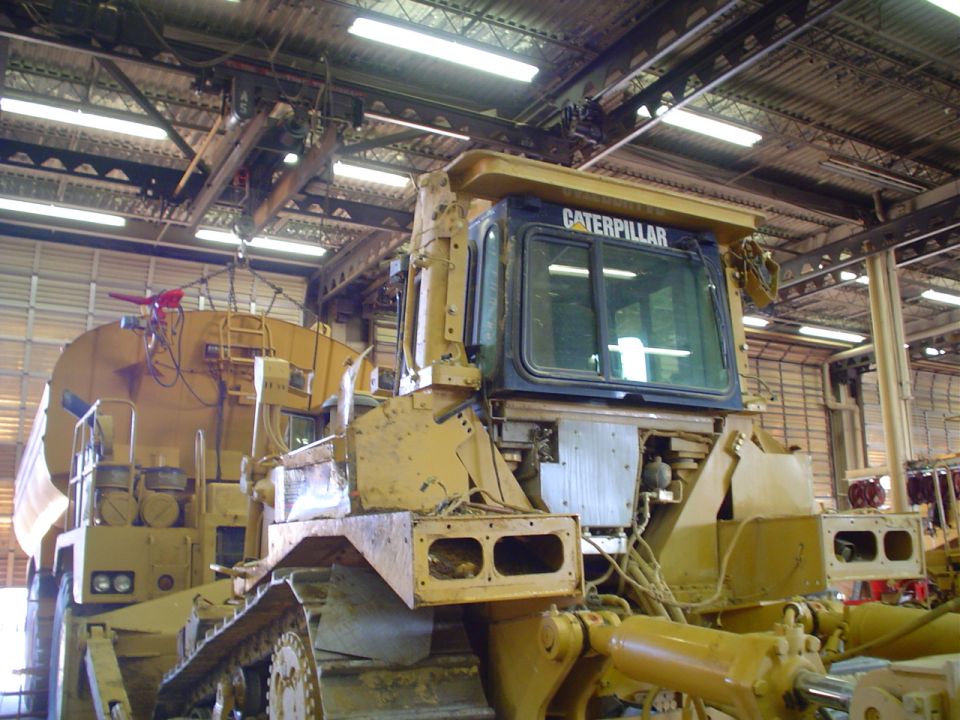 Yellow Caterpillar bulldozer cab with 'CATERPILLAR' text