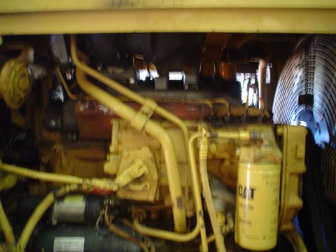 1966 International School Bus - The engine compartment shows a CAT filter and a large fan, with yellow hoses and components.
