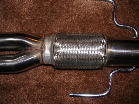 1996 Ford Probe - Close-up of a vehicle exhaust system part, showing a flexible connector and hangers.