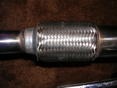 1996 Ford Probe - Close-up of a braided metal exhaust flex pipe, likely an aftermarket part.
