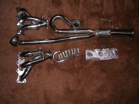 1996 Ford Probe - Aftermarket exhaust headers and associated hardware are displayed on a brown background.